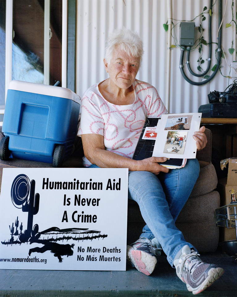 Ajo resident, Gayle Weyer, holding a folder containing photos she collected of of human remains discovered in Aqua Prieta area, Ajo, AZ, May, 2019